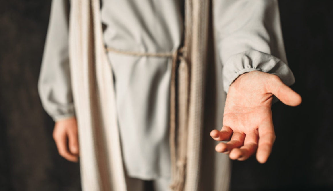 Man in the image of Christ reaching out his hand